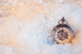 New year, almost midnight. Festive background, antique clock in the snow