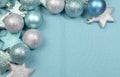 Festive background of aqua pale blue christmas glitter baubles w' copy space