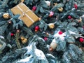 Festive background of blue Christmas tree branches covered with snow, with golden, red balls, garlands and a gift box. Copy space Royalty Free Stock Photo
