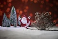 Festive background. Christmas decorations. Santa Claus (or Snowman) standing on snow with beautiful decorated background with Royalty Free Stock Photo