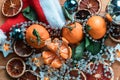 Festive background of citrus, garlands, dried fruits, Christmas and new year coming soon. Royalty Free Stock Photo