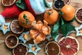 Festive background of citrus, garlands, dried fruits, Christmas and new year coming soon. Royalty Free Stock Photo