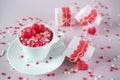 Coffee cup, full of multicolor sweet sprinkles sugar candy hearts and packing Valentine`s Day gifts. Love and Valentine`s day Royalty Free Stock Photo