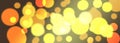 Festive background with defocused orange and golden bokeh lights, sparkles or glitter background