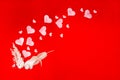 Festive background with enamored kissing birds and hearts on a red background. Valentine's day card or wedding