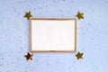 Festive background. Gold photo frame, small shiny confetti, place for text, blue background