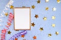 Festive background. Gold photo frame, small shiny confetti, serpentine. Place for text, gold stars, blue background