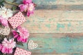 Festive background with pink peonies, gifts and hearts on an old turquoise table with shabby paint. Place for text Royalty Free Stock Photo