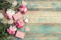 Festive background with pink peonies, gifts and hearts on an old turquoise table with shabby paint. Place for text Royalty Free Stock Photo