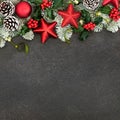 Festive Background with Red Star Baubles and Winter Flora Royalty Free Stock Photo