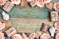 Festive background with rose flowers, gifts and birds on shabby wooden turquoise boards. Frame top down composition with copy Royalty Free Stock Photo