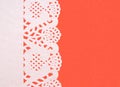 Festive background white paper doily on textured red background