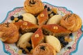 Festive baking for the holiday of Navruz. Shekerbura, baklava, puff pastry with salted filling, on a plate with blue frame.