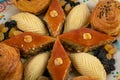 Festive baking for the holiday of Navruz. Shekerbura, baklava, puff pastry with salted filling, white and black raisins.