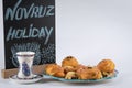 Festive baking for the holiday of Navruz.Shekerbura, baklava, puff pastry with salted filling, on a plate.White glass armudu.