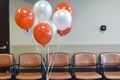 festive balloons floating above the waiting area chairs Royalty Free Stock Photo