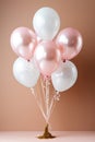 Festive balloons in pale metallic pink and white in a bouquet or bundle