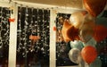 Festive balls and glowing garlands at home on the window, beautiful bright celebration background and texture