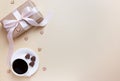 Banner of Valentine`s Day. A Cup of coffee, a gift box and a heart-shaped chocolate on a neutral beige background Royalty Free Stock Photo