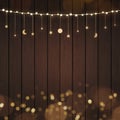 Beautiful Warm White String Lights and Golden Garland on Dark Brown Wood Texture