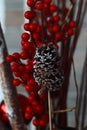 festive berries and a decorative acorn lightly dusted with white snow.