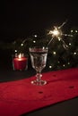 Festive beverage with the sparkler in it on a black background. Christmas decorations Royalty Free Stock Photo