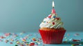 A festive birthday cupcake with a lit candle and colorful sprinkles..AI generated image Royalty Free Stock Photo
