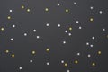 Festive black background with silver and gold star confetti