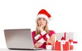 Festive blonde shopping online with laptop Royalty Free Stock Photo