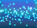 Festive blue bokeh background. Holiday glowing colored lights with sparkles.