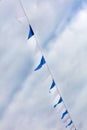 Festive blue white flags against the sky with clouds Royalty Free Stock Photo