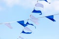 Festive blue white flags against the sky with clouds Royalty Free Stock Photo
