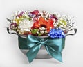 Festive bouquet of fresh flowers in a pot with a bow.
