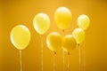 Festive bright minimalistic balloons on yellow background.