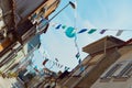 Festive bunting and lanterns decorate a narrow street for summer festival in June San Juan Royalty Free Stock Photo