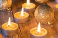 Warm Christmas atmosphere with golden candles and glittering baubles Royalty Free Stock Photo