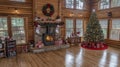 Festive Cabin Christmas A Cozy Holiday Haven with Fireplace  Tree Royalty Free Stock Photo