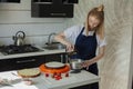 Festive cake decoration.A young woman is preparing cream for a cake. Cake. Royalty Free Stock Photo