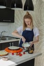 Festive cake decoration.A young woman is preparing cream for a cake. Happy. Royalty Free Stock Photo