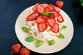 A festive cake with fresh strawberries, cream, decorated with mint leaves Royalty Free Stock Photo