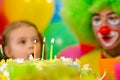 Festive cake with three candles, kid with clown Royalty Free Stock Photo