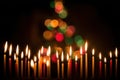 Festive Candlelight with Colorful Bokeh Holiday Background. Royalty Free Stock Photo