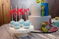 Festive candy bar for 5 years old boy birthday party. Blue cakepops with red bows. Sweets for family event.