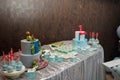 Festive candy bar for 1 and 5 years old boys birthday party. Cake with red number 1 and butterfly bow on shirt. Blue cakepops