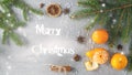 Festive card with fresh sweet mandarins, fir branch, anise, cinnamon and artificial snowflakes. Royalty Free Stock Photo