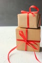Festive cardboard boxes wrapped in red ribbon on the table Royalty Free Stock Photo