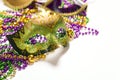 Festive Carnival mask and beads on a white background