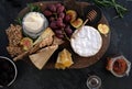 Cheeseboard with a variety of cheeses, crackers, fruit, honey, rosemary sprigs and chutney Royalty Free Stock Photo