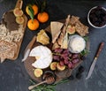 Cheeseboard with a variety of cheeses, crackers, fruit, honey, rosemary sprigs and chutney Royalty Free Stock Photo