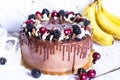 Festive chocolate cake with blackberry and sweet cherry on a white background. Side view